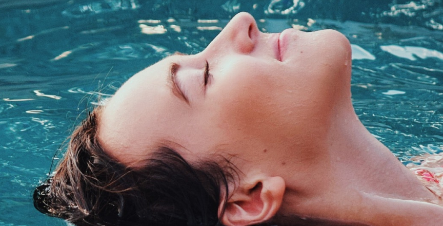 woman with head back in water