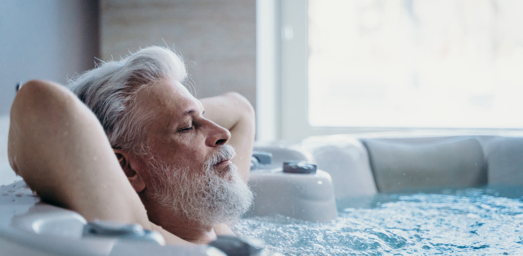 older male relaxing in hot tub